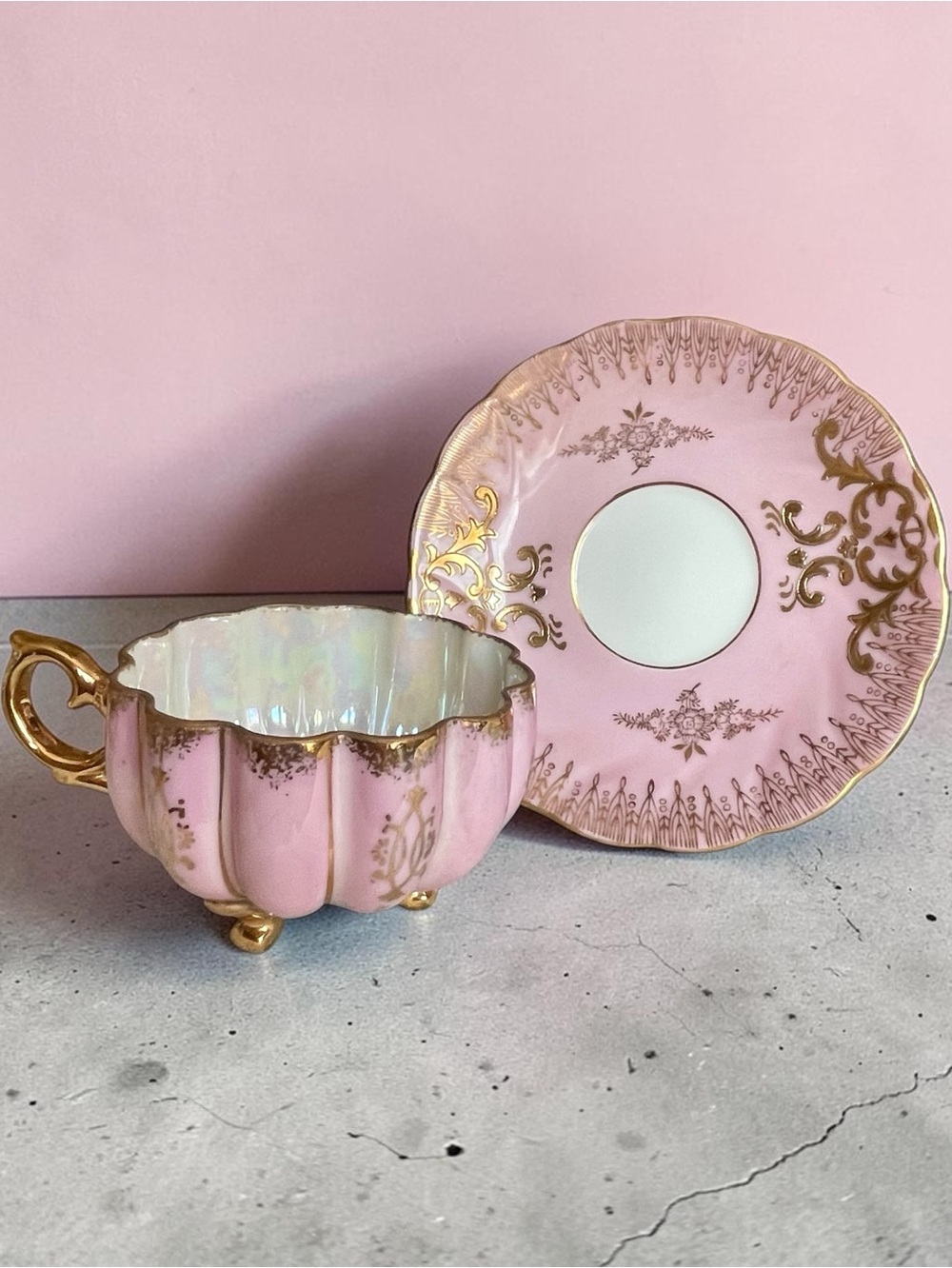 Lusterware teacup & saucer, melon shaped cup on 3 gilded feet, iridescent